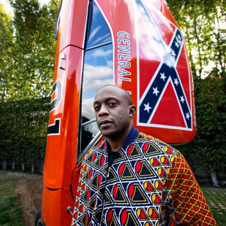 Portrait of Hank Willis Thomas in front of Duke's of Hazaard inspired car sculpture at Kayne Griffin, Los Angeles